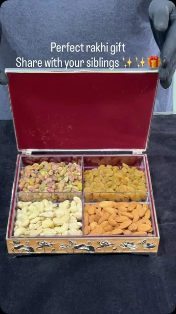 Silver-finish dry fruit box filled with cashews, almonds and raisins