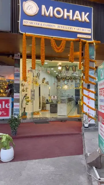 Mohak storefront with its blue 925 Silver and Fashion Jewellery sign and marigold garlands